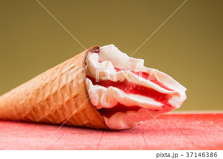 Strawberry ice cream cone in the hand isolated Strawberry ice cream cone in the hand isolated 37146386