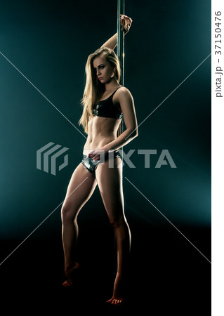 Sexy dancer in latex lingerie posing with pylon 37150476