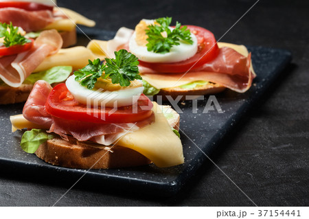 Delicious sandwich with prosciutto ham 37154441