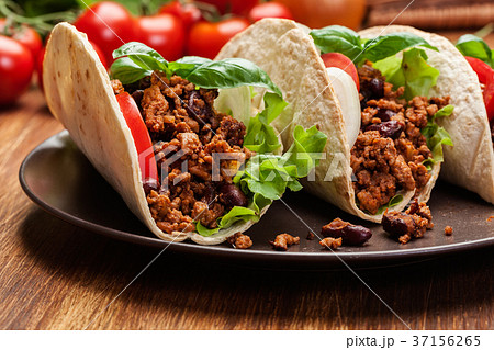 Mexican tacos with minced meat, beans and spices 37156265