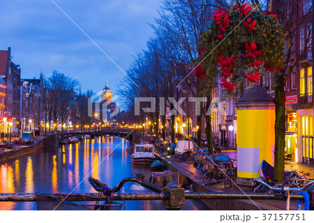 Night illumination of Amsterdam canal and bridge Night illumination of Amsterdam canal and bridge 37157751
