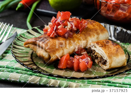 Mexican chimichanga with salsa dip Mexican chimichanga with salsa dip 37157925