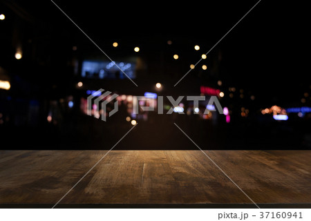 Empty dark wooden table in front of abstract 37160941