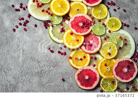 group of sliced citrus with pomegranate seeds group of sliced citrus with pomegranate seeds 37165372