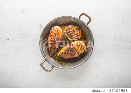Roasted chicken breast with bacon and garlic. Roasted chicken breast with bacon and garlic. 37165963