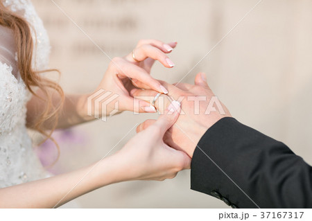 wedding rings and hands of bride and groom. young wedding rings and hands of bride and groom. young 37167317