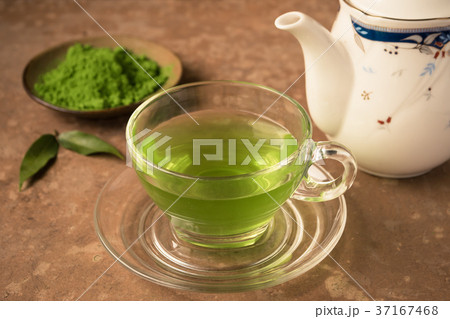 Glass cup of hot tea with green tea powder Glass cup of hot tea with green tea powder 37167468