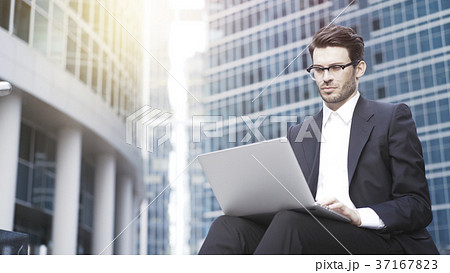 Front view of a handsome young businessman working 37167823