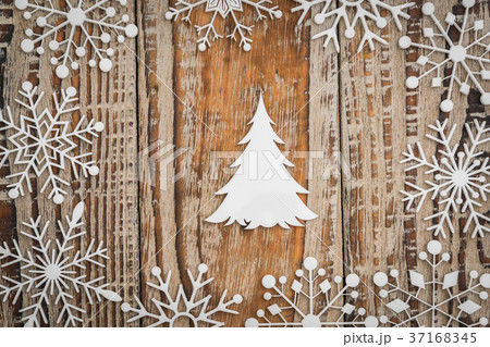 Paper snowflakes on wooden background . Paper snowflakes on wooden background . 37168345