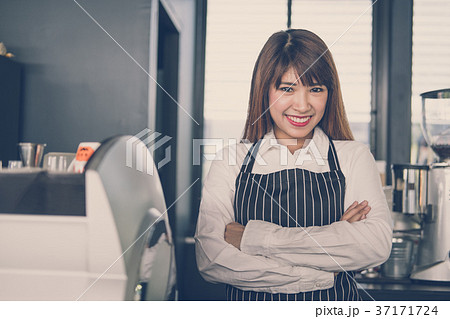 small business owner standing at counter in coffee shop female