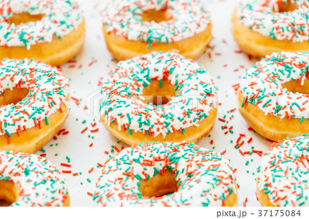 Donuts with white chocolate cream and sprinkles sugar 37175084