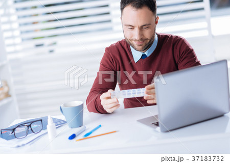 Handsome man smiling while looking at the tiny 37183732