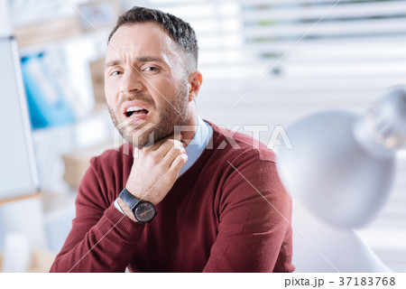 Emotional worker touching his neck and having a Emotional worker touching his neck and having a 37183768