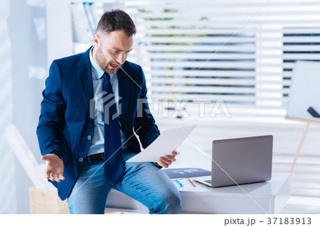 Outraged man looking at the documents after being Outraged man looking at the documents after being 37183913