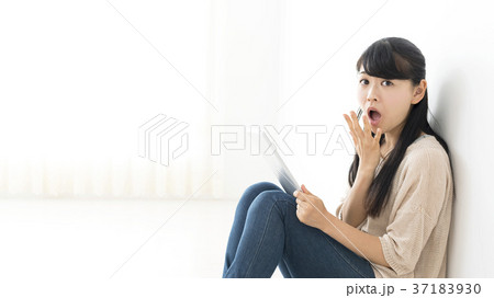タブレットを見て驚く若い女性 タブレットを見て驚く若い女性 37183930