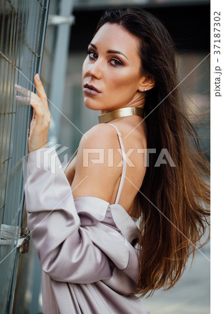 Fashion portrait of a sexy girl in a coat and 37187302