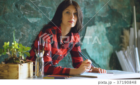 Young woman artist painting sketch on paper 37190848