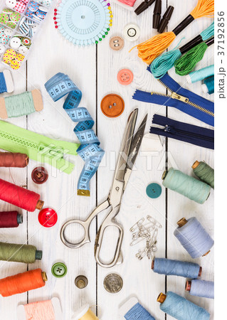 Old scissors, buttons, threads and measuring tape Old scissors, buttons, threads and measuring tape 37192856