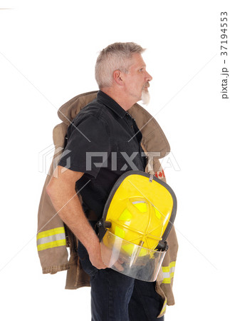 A firefighter standing in profile A firefighter standing in profile 37194553