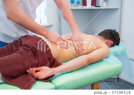 hands of the masseur - young man's back  37196318