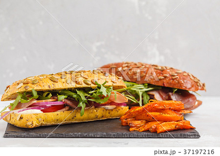 Sandwiches with ciabatta, meat, bacon, vegetables 37197216