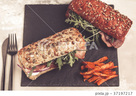 Sandwiches with ciabatta, meat, bacon, vegetables 37197217