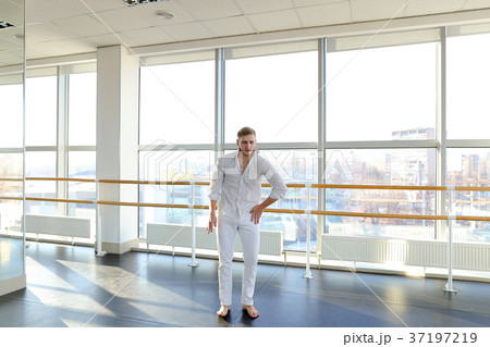 Male dancer making one arm handstand. 37197219