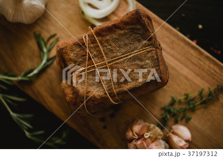 Chunk of salted smoked lard in gauze with a rope 37197312