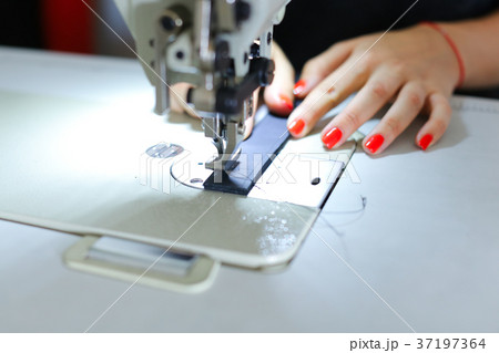 Seamstress sewing belt using sewing machine. Seamstress sewing belt using sewing machine. 37197364