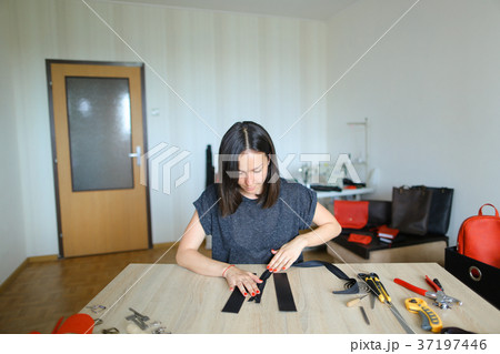 Student learning to sew zipper on purse. Student learning to sew zipper on purse. 37197446