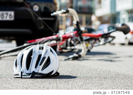 Close-up of a bicycling helmet on the asphalt nex Close-up of a bicycling helmet on the asphalt nex 37197549