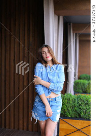 Young lady walking near restaurant and playi Young lady walking near restaurant and playi 37197845
