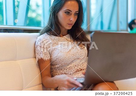 Female hands on keyboard with opened web page in 37200425