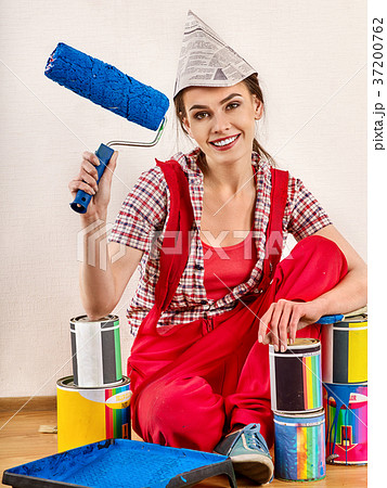 Repair home woman holding paint roller for Repair home woman holding paint roller for 37200762