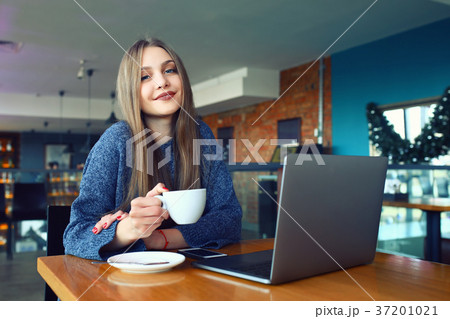 beautiful young girl resting in a cafe. Toned 37201021