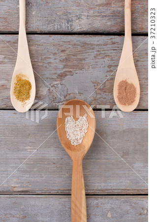 Wooden spoons with seasoning, top view. Wooden spoons with seasoning, top view. 37210323