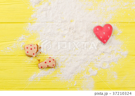 Flour and cookies on yellow background. 37210324