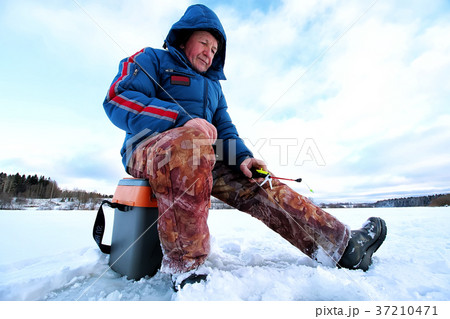 Winter season old man fishing on lake Winter season old man fishing on lake 37210471
