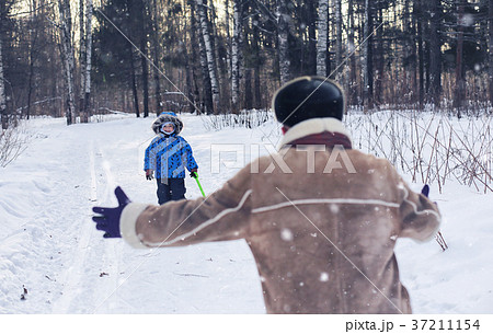 Kid playing in a winter park and have fun with Kid playing in a winter park and have fun with 37211154