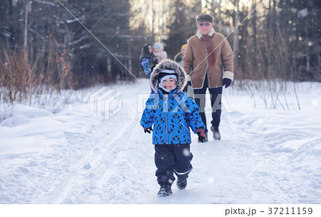 Kid playing in a winter park and have fun with Kid playing in a winter park and have fun with 37211159