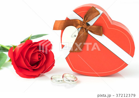 Red rose and heart-shaped box on white Red rose and heart-shaped box on white 37212379