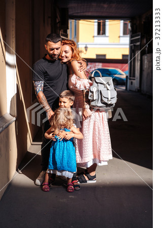 beautiful parents and their cute little kids 37213333