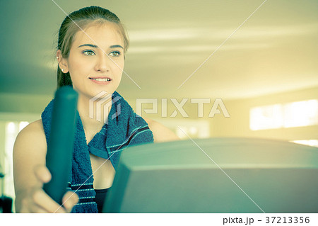 Woman looking motivated working out on treadmill Woman looking motivated working out on treadmill 37213356
