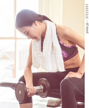 Strong woman is lifting dumbbell workout Strong woman is lifting dumbbell workout 37213357