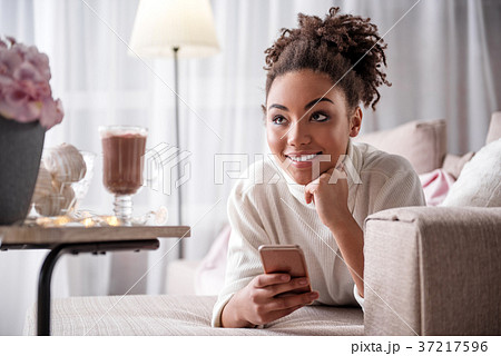 Dreamful african girl relaxing on couch with Dreamful african girl relaxing on couch with 37217596