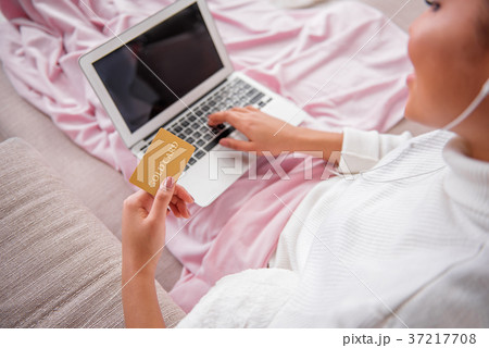 Girl buying things in internet at home 37217708