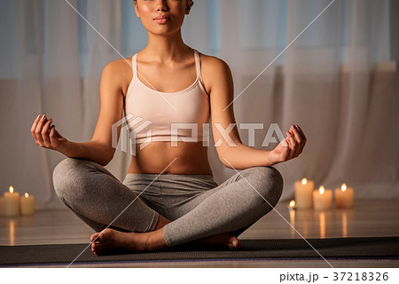 Serene girl doing relaxing yoga in room 37218326