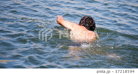 The man is swimming in the lake The man is swimming in the lake 37218594