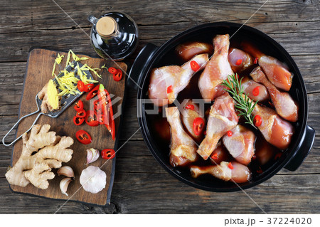 raw chicken drumsticks in black pot raw chicken drumsticks in black pot 37224020