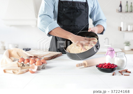 A cook with eggs on a rustic kitchen against the 37224168
